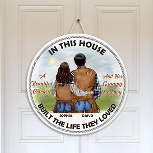 Cowboy Couple In This House They Built The Life They Loved Personalized Round Wooden Sign - Wood Sign - GoDuckee